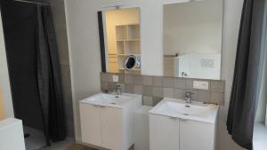 a bathroom with two sinks and a mirror at B-SIDE Loppem in Zedelgem +20 photos