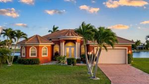 a house with palm trees in front of it at Villa Princess in Cape Coral