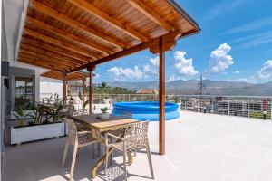 a patio with a table and chairs and a hot tub at Hotel&Apartaments -Villa Hasani 24 in Sarandë