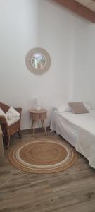 a bedroom with a bed and a table and a mirror at Villa Audrey in Cala en Bosc +26 photos