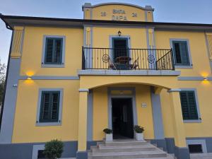 a yellow house with a balcony on top of it at Vila Dara 1924 in Tivat