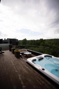 a hot tub on the deck of a building at Liso Prostir in Lisopotik
