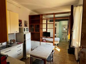 a kitchen with a table and a kitchen with a dining room at I Liutai 2P in Cremona