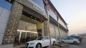 a white car parked in front of a building at Taleen Serviced Apartments Granada- تالين غرناطة للشقق المخدومة in Riyadh