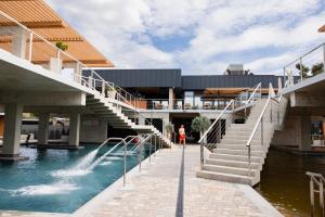 a building with stairs and a fountain in the water at Magnum in Berehove