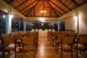 a room with rows of chairs and a table in it at Skyleaf Resort in Meenangadi +24 photos