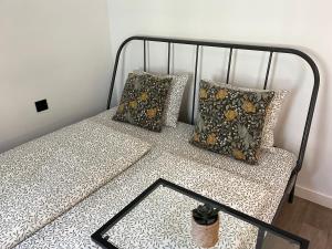 a bed with two pillows on top of it at Near Ozas Studio in Vilnius