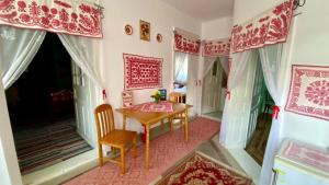 a dining room with a wooden table and chairs at Golyafeszek Vendeghaz in Sîncraiu