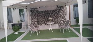 a room with a table and chairs and a wall at Spacious seaside house in Nea Makri in Nea Makri
