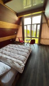 a bedroom with a large bed in a tent at Raiyar Resort doodhpathri in Rengazabal