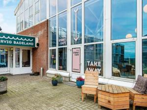 a store front of a brick building with windows at Premium apartment with loft in holiday park in Ringkøbing