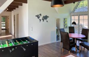 a living room with a foosball table and a dining room at Penthouse in Hobro +11 photos