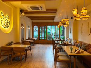 a restaurant with tables and chairs in a room at Vista10 in Bhopal