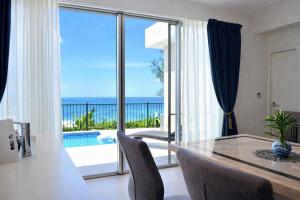a dining room with a view of the ocean at -Villa Rikyu- 離宮 in Miyako-jima