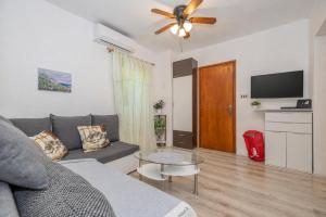 a living room with a couch and a table at Apartment Dinka in Kornić