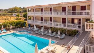 a large hotel with a swimming pool and a building at Bona Vista Studios in Laganas