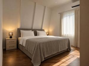 a bedroom with a large bed and a window at Qafqaz Front Falcon Chalet in Gabala +26 photos