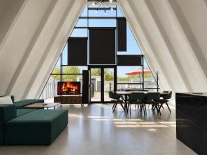 a living room with a couch and a fireplace at Qafqaz Front Falcon Chalet in Gabala