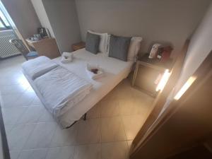 a bed with white sheets and pillows in a room at Villa Josefine Lake Front beach and Pool in Brenzone sul Garda +58 photos