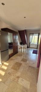 a kitchen and dining room with a table and refrigerator at Villa Varco in Auxonne +12 photos