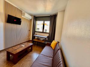 a living room with a couch and a table at Perita Apartamentos in Mataró