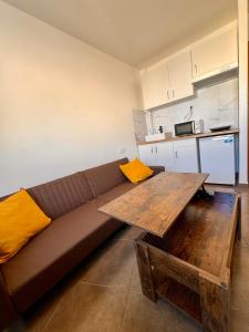 a living room with a couch and a wooden table at Perita Apartamentos in Mataró