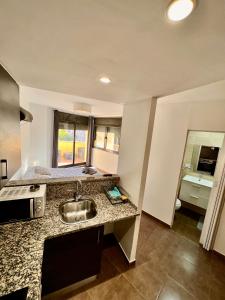 a kitchen with a sink and a counter top at Perita Apartamentos in Mataró +68 photos