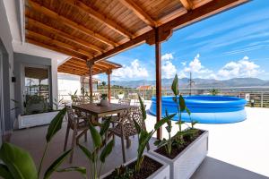 an outdoor patio with a table and inflatable rafts at Hotel&Apartaments -Villa Hasani 24 in Sarandë
