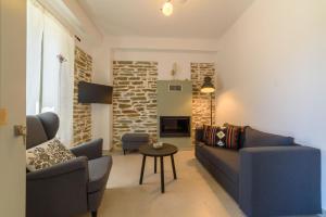 a living room with two couches and a table at Orange House - Lower West appartment in Promírion