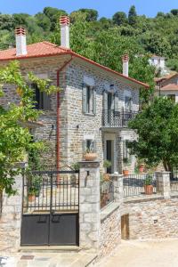 a stone house with a gate in front of it at Orange House - Lower West appartment in Promírion