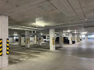 an empty parking garage with cars parked in it at Near Ozas Studio in Vilnius