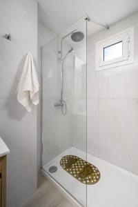 a bathroom with a shower with a glass door at Amalia in Matala +49 photos