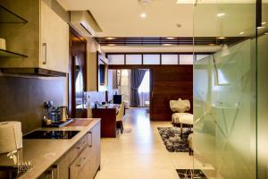 a kitchen with a living room and a dining room at Oak Plaza Suites in Kumasi