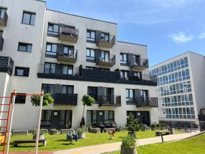 an apartment building with a playground in front of it at Near Ozas Studio in Vilnius