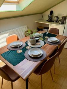 a wooden table with plates and dishes on it at Pension 311 Vrchlabí in Vrchlabí