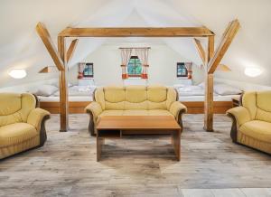 a room with two chairs and a couch and a bed at Penzion Čítkův Mlýn in Šluknov