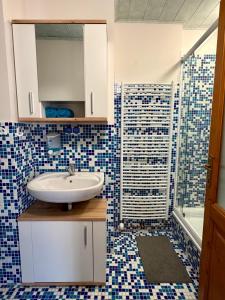 a bathroom with a sink and a shower at Pension 311 Vrchlabí in Vrchlabí +26 photos