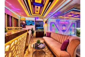 a living room with a couch and a video game at Hotel Sairaj inn - Restaurant - Free Wi-Fi - Premium Rooms - Balcony - Parking in Puri +21 photos