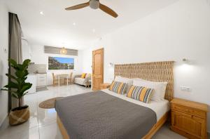 a bedroom with a bed and a living room at Amalia in Matala