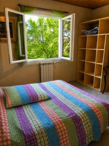 a bedroom with a large bed with a window at Santon in Eugénie-les-Bains