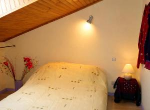 a bedroom with a large bed in a room at Santon in Eugénie-les-Bains