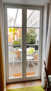 a sliding glass door with a view of a patio at Wanderer und Radlerzimmer in Lieser +4 photos