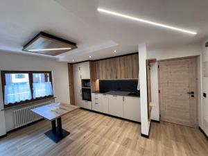 a large kitchen with a table in a room at Villa L'Aida in Canazei