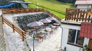 an overhead view of a patio with tables and umbrellas at Hotel Sonnenalm Stuhleck in Spital am Semmering