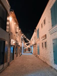 an empty street at night with lights on buildings at Amber Butik Otel in Çeşme