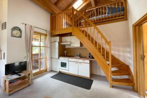 a kitchen with a spiral staircase in a house at Apartman Pepa in Bayerisch Eisenstein