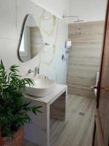 a bathroom with a sink and a mirror at VintageVilla in Skala Marion +33 photos