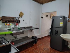 a kitchen with a sink and a refrigerator at EcoHonda Low Cost in Honda