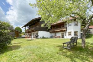 a bench sitting in the yard of a house at Apartman Pepa in Bayerisch Eisenstein