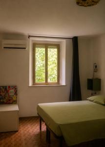 a bedroom with a bed and a window at Il Gelsomino Storico in Empoli